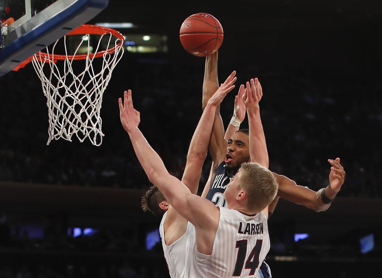 Villanova guard Mikal Bridges (25) dunks the ball against Gonzaga forward Killian Tillie, left, and center Jacob Larsen (14) during the second half of an NCAA college basketball game, Tuesday, Dec. 5, 2017, in New York. Villanova won 88-72.