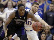 Kansas' Sviatoslav Mykhailiuk (10) tries to steal the ball from Washington's Noah Dickerson (15) during the first half of an NCAA college basketball game Wednesday, Dec. 6, 2017, in Kansas City, Mo.