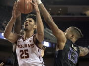 Southern California forward Bennie Boatwright, left, shoots under pressure from Washington forward Hameir Wright, right, during the second half of an NCAA college basketball game Friday, Dec. 29, 2017, in Los Angeles.