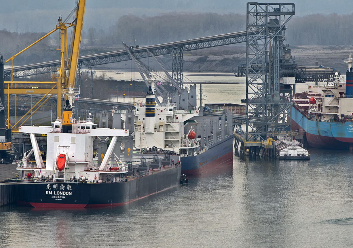 A small boat moves around the bow of the KV London at the Port of Longview Friday afternoon. Engineers and divers were inspecting the hull after the month-old vessel went aground in the Columbia River Thursday evening.