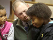 Joey Gilbert of Carnesville, Ga., talks to Alasjah Haynes, 7, of Waveland, and her sister, Jada, 12, before services at Bayside Baptist Church in Waveland on Sunday, Dec. 17, 2017.