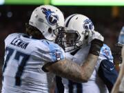 Tennessee Titans offensive tackle Taylor Lewan (77) congratulates quarterback Marcus Mariota (8) after he scored a touchdown against the Kansas City Chiefs during the second half of an NFL wild-card playoff football game, in Kansas City, Mo., Saturday, Jan. 6, 2018.