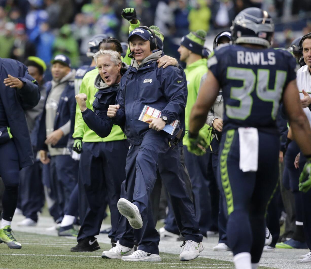 Seattle Seahawks head coach Pete Carroll, left, and offensive coordinator Darrell Bevell, right, celebrate a touchdown against the Philadelphia Eagles on Sunday, Nov. 20, 2016, in Seattle.