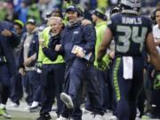 Seattle Seahawks head coach Pete Carroll, left, and offensive coordinator Darrell Bevell, right, celebrate a touchdown against the Philadelphia Eagles on Sunday, Nov. 20, 2016, in Seattle.