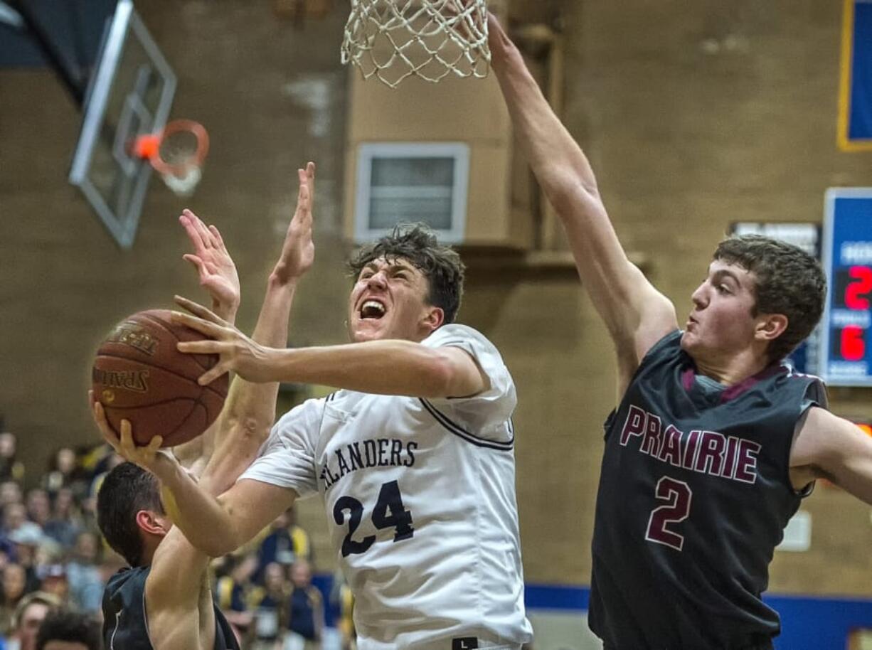 Kelso’s Shaw Anderson (24) drives to the basket past Prairie’s Dante Heitschmidt (2). Anderson had a game-high 29 points in Kelso’s win.