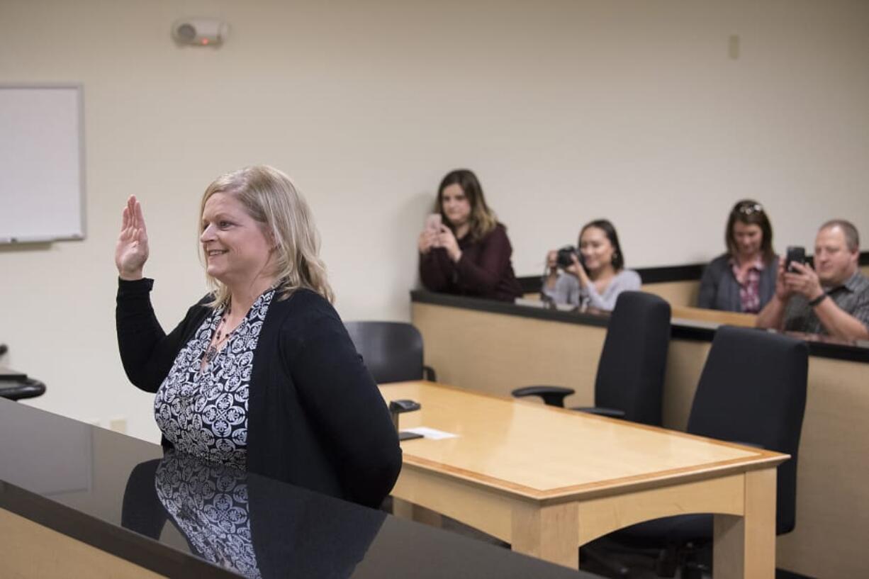 Michelle White, who passed the Limited License Legal Technician exam given by the Washington State Bar Association to become a legal technician, is sworn in on Oct. 31 by Clark County Superior Court Judge Suzan Clark at the Family Law Annex in Vancouver. White is the first legal technician in Clark County.