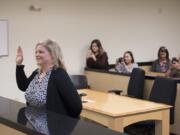 Michelle White, who passed the Limited License Legal Technician exam given by the Washington State Bar Association to become a legal technician, is sworn in on Oct. 31 by Clark County Superior Court Judge Suzan Clark at the Family Law Annex in Vancouver. White is the first legal technician in Clark County.