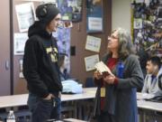 Tristan Todd, 18, left, talks to substitute teacher Carolyn Rose during his senior English class at Hudson’s Bay High School in December. Rose has been substitute teaching in Vancouver since 2001.