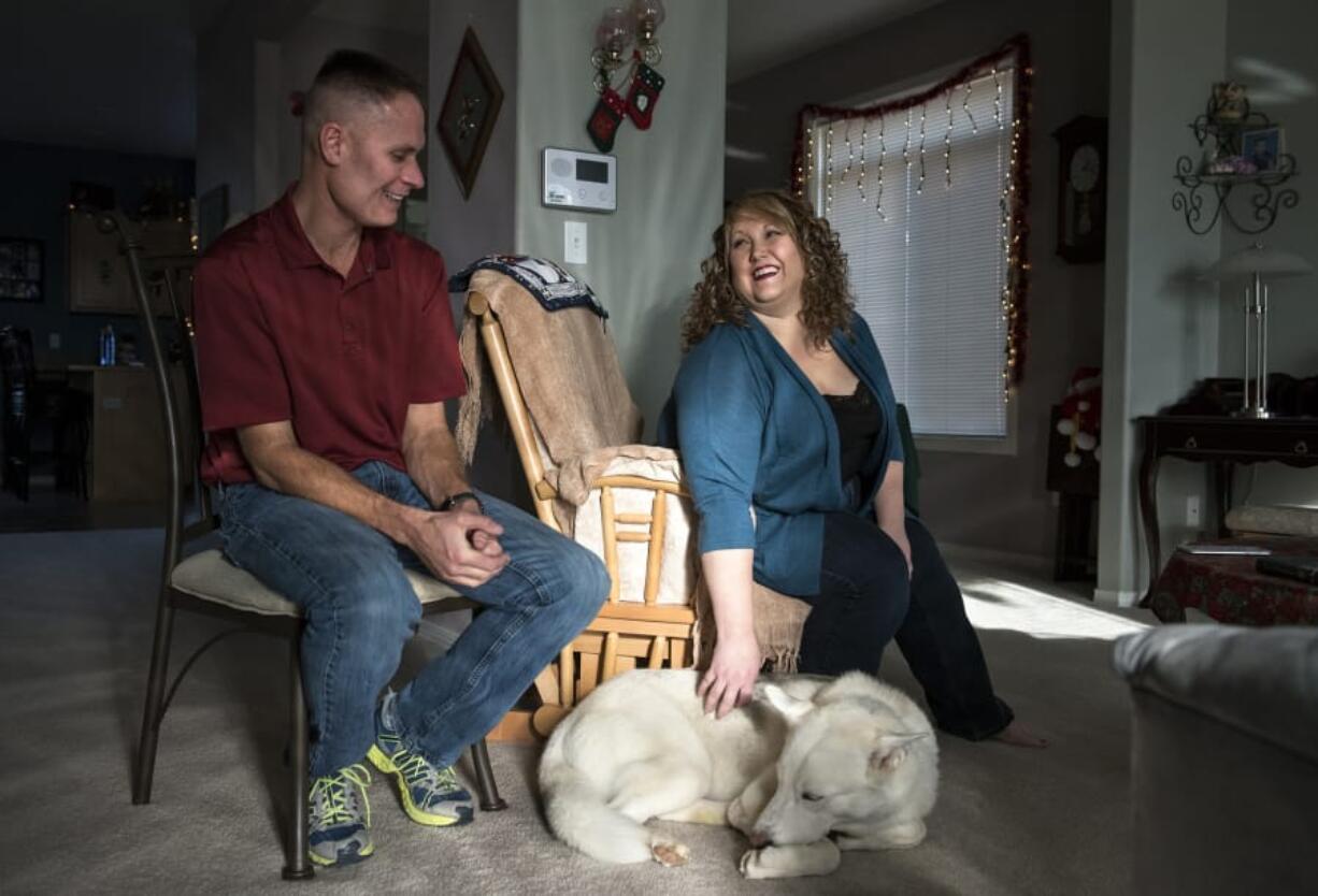 Eric and Tonya Imhoff sit with their new husky, Jasmine, as they talk about her adoption at their home in Battle Ground in mid-December. The Humane Society for Southwest Washington in Vancouver celebrated Veterans Day weekend by waiving adoption fees for active-duty service members and veterans. It was the busiest weekend ever for adoptions at the organization’s Vancouver shelter, officials said.