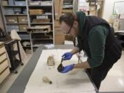 James Kice, administrative assistant for Clark County Historical Museum, looks over a comb that was recovered when they built one of The Columbian’s parking lots.