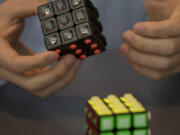 Skyview High School senior Carson Mowrer, 17, describes how the tactile Rubik’s Cube works so people with visual impairments can solve the puzzle.