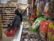 Angelica Guzman of Guam picks out dried shredded squid snacks to make a care package for her fiancé at Tola Angkor Asian Market in Vancouver on Thursday, Jan. 11, 2018. Guzman is in Vancouver visiting family and is exploring different asian markets in the area to find some of her favorite ingredients. "I like to cook a mixed cuisine for my kids," she said.