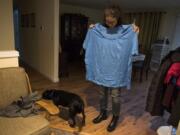 Meghan Green holds up one of her old shirts on Tuesday afternoon in her Ridgefield home.