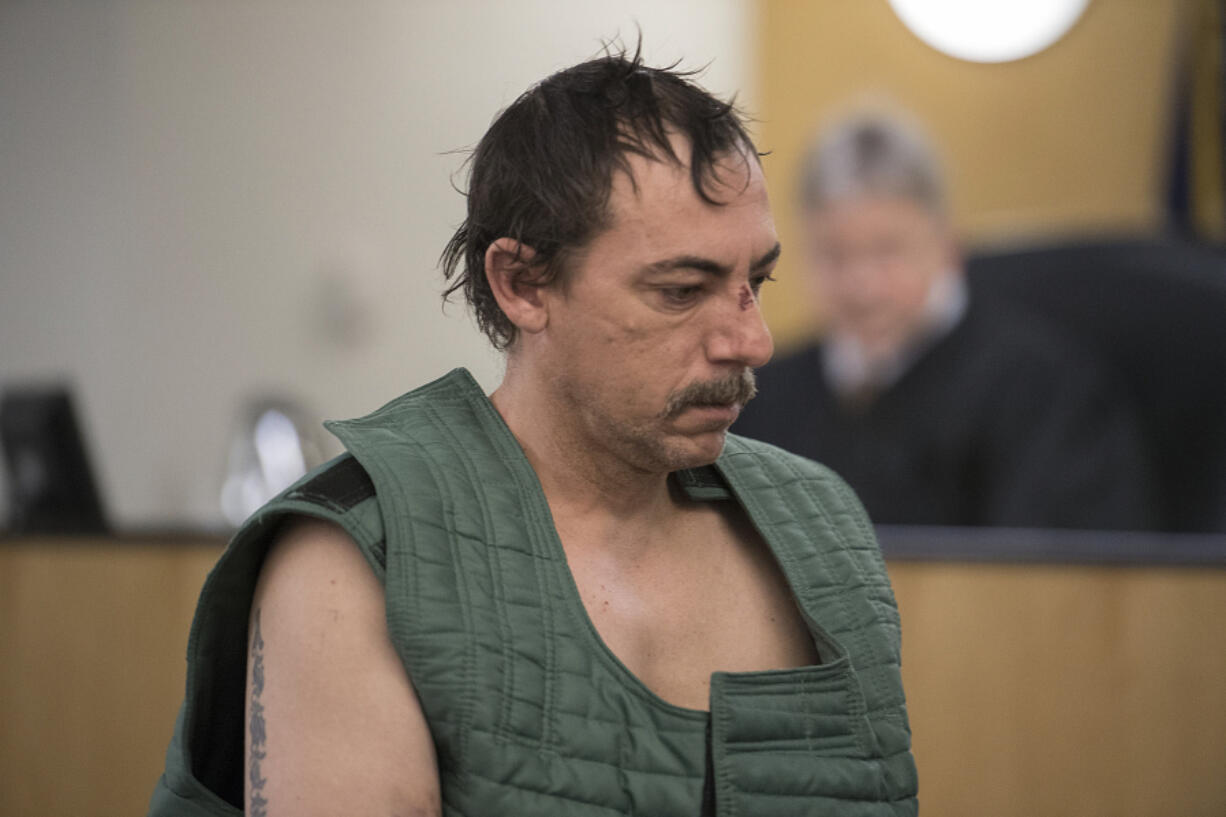 Robert W. Clark, 42, makes a first appearance Tuesday in Clark County Superior Court. He is accused of brutally attacking his wife Sunday night at a Vancouver hotel.