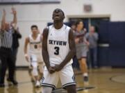 Skyview's Samaad Hector (3) celebrates a three-pointer by teammate Alex Schumacher (0) during the final minutes of Friday night's game against Union at Skyview High School in Vancouver on Jan. 5, 2018. Skyview defeated Union 59-55.