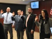 Battle Ground councilors, from left, Brian Munson, Mike Dalesandro, Adrian Cortes and Cherish DesRochers are sworn in for their new terms at Tuesday night’s meeting. Dalesandro was selected by his fellow councilors to be the city’s mayor for the next two years.