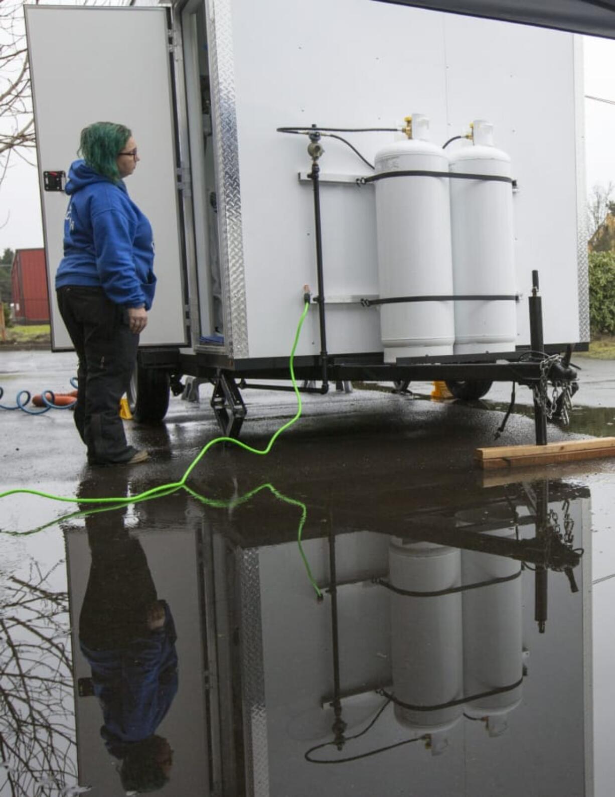 Jamie Spinelli prepares a mobile showering truck for use at Living Hope Church in Vancouver on Sunday. Homeless beneficiaries could grab a hot meal, coffee and, thanks to the efforts of the nonprofit group Food with Friends, a shower.