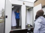 Jamie Spinelli  left prepares a mobile showering car for use at the Living Hope Church in Vancouver on Sunday.