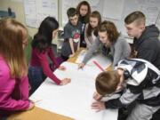 Eighth-graders at Laurin Middle School work together on design plans for their new middle school Friday during their hands-on science elective class led by Joan Smith. Students are split into different teams to design an imagined version of the Brush Prairie school.