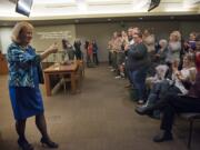 The crowd gives Vancouver Mayor Anne McEnerny-Ogle a standing ovation after she is sworn in during the first city council meeting of the year at City Hall in Vancouver on Monday.