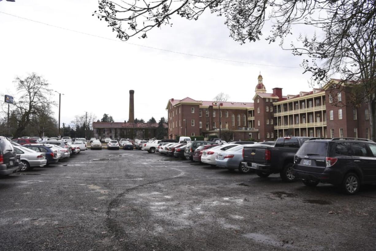 The parking lot west of Providence Academy, along C Street, pictured Friday. Filings with the city of Vancouver show plans to build two mixed-use buildings and parking there.