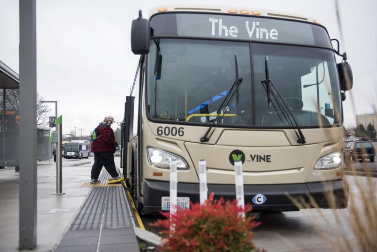 Vancouver resident and regular C-Tran rider Cathy Chidester of Vancouver boards a Vine bus at the Vancouver Mall Transit Center on Tuesday afternoon. Tuesday marked the first anniversary of The Vine, C-Tran’s bus rapid transit system. Agency officials say The Vine is faster, more efficient and serves more people than the traditional bus route it replaced.