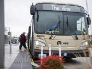 Vancouver resident and regular C-Tran rider Cathy Chidester of Vancouver boards a Vine bus at the Vancouver Mall Transit Center on Tuesday afternoon. Tuesday marked the first anniversary of The Vine, C-Tran’s bus rapid transit system. Agency officials say The Vine is faster, more efficient and serves more people than the traditional bus route it replaced.