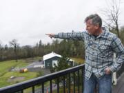 Sean Streeter points toward a gravel pit across Gibbons Creek that he says has disturbed the peace and quiet his family has enjoyed living outside of Washougal.