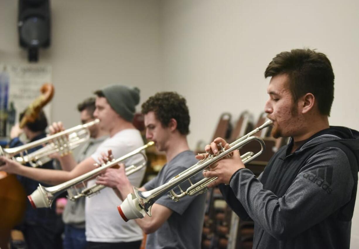 Ariane Kunze/The Columbian Clark College Jazz Ensemble trumpet players Bryce Robertson, left, Connor Wier and Ernest Mattson get ready for the 56th annual Clark College Jazz Festival.