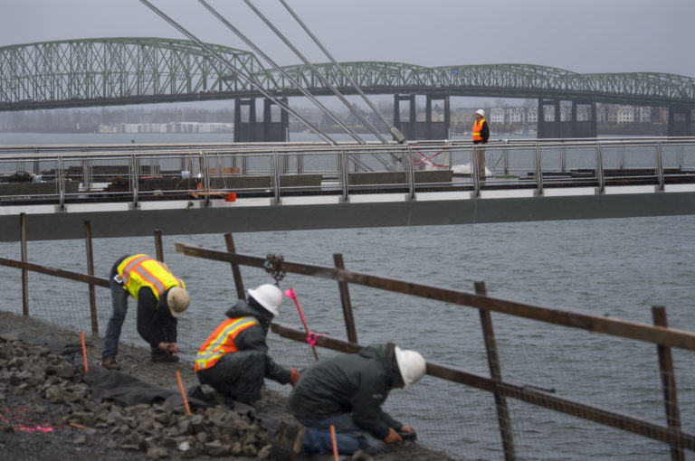 Terry Snyder, top, City of Vancouver landscape architect, takes in the view from the Grant Street Pier as it floats over the Columbia River using only its own cables Thursday morning, Jan. 11, 2018. The pier recently had the pilings removed.