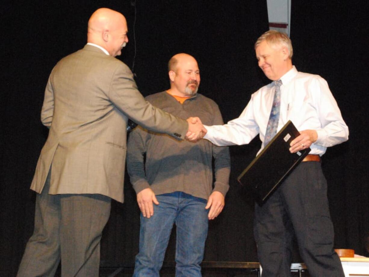 Woodland: Green Mountain School District Superintendent Tyson Vogeler, left, honored outgoing school board member Garren Elmer, center, for his 16-plus years of work and board chairman Rick Syring, right, with the Washington State School Directors’ Association Certificate of Appreciation for 30 years of service on the board.