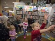 James Tobin, 4, of Ridgefield, in red, joins other participants in children’s story time as they enjoy playing with bubbles at Ridgefield Community Library.