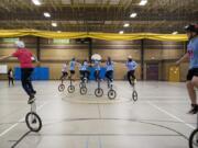 A spinning line of extra-tall “giraffe” unicyclists rehearses staying linked, and staying graceful, while balancing five feet over the floor of the Pleasant Valley Middle School gym. The Pleasant Valley Unicycle Team displays its unlikely skills during halftime shows for sports games all over Clark County.