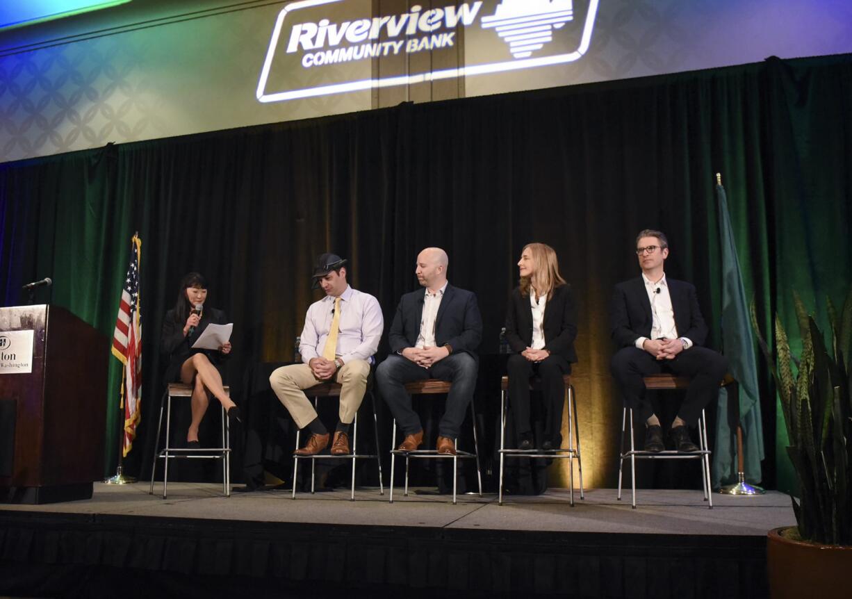 Moderator Mei Wu, from left, joins panelists Andy Lowery of RealWear, Kevin Getch of Webfor, Dorota Shortell of Simplexity Product Development and Aaron Holm of Blokable Inc. during the 2018 Economic Forecast Breakfast at the Hilton Hotel in downtown Vancouver, Thursday morning January 18, 2018.