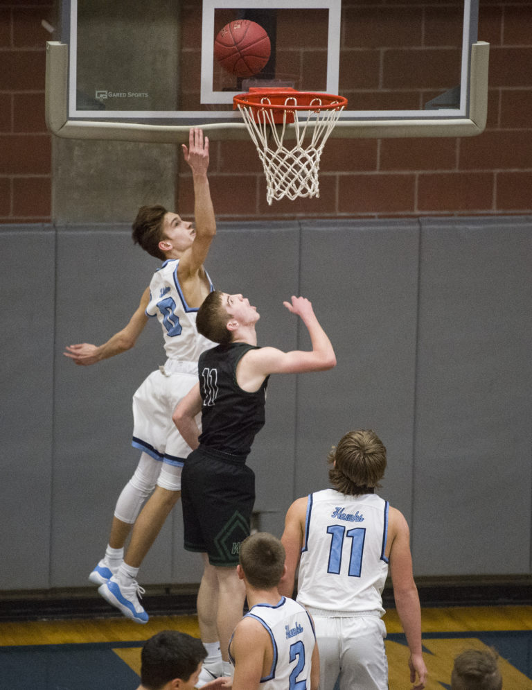 Hockinson’s Ryan Cooney (0) makes a shot past Woodland’s Isaiah Flanagan (11) during a game at Hockinson High School, Friday January 19, 2018.