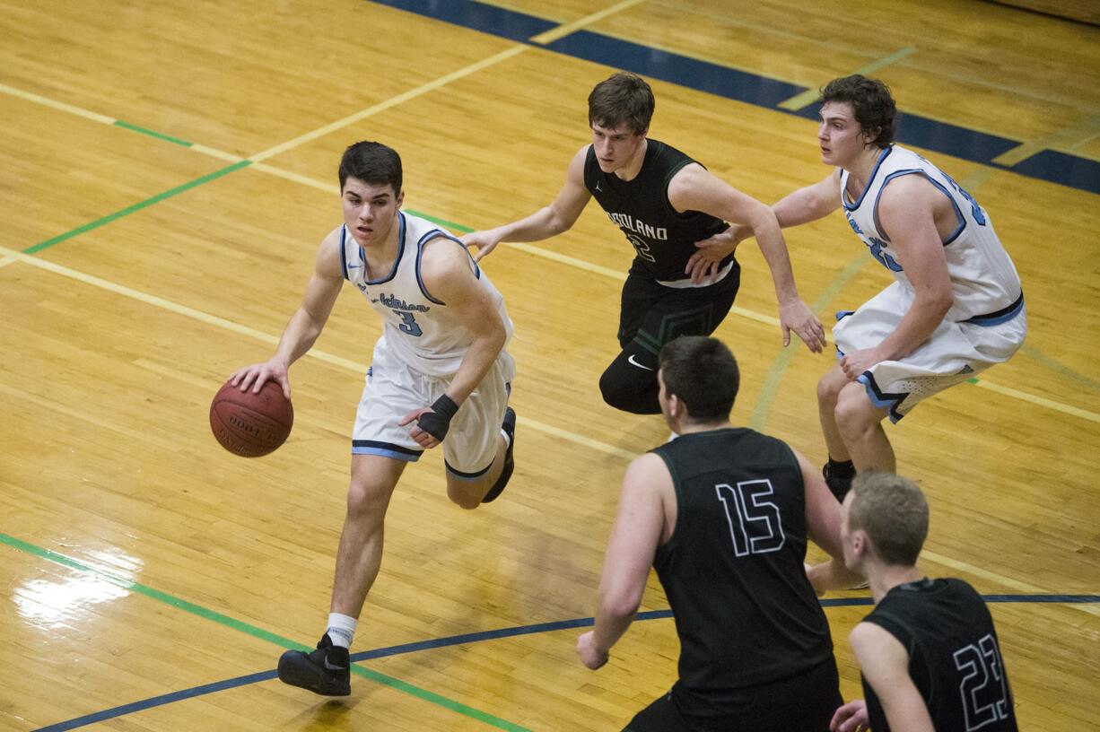 Hockinson’s Peyton Brammer (3) avoids Woodland’s Palmer Dinehart (15) and Wyatt Harsh (2) during a game at Hockinson High School, Friday January 19, 2018.