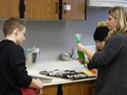 Ridgefield: Stefanie Foster, Ridgefield High School’s family and consumer science teacher, working with students during their Cupcake Wars competition, in which they had to research, bake and present a cupcake recipe.