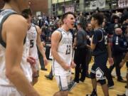 Union's Ethan Smith (23) celebrates Tuesday night's win against Skyview at Union High School on Jan. 23, 2018. The Titans won 72-69.