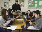 Evergreen High School students involved in Upward Bound, a college preparation program for first-generation college students, work on their résumés with guidance from Upward Bound Program Coordinator Arturo Santana, center left, and Upward Bound Program Director Maria Cabrera, center right, at Evergreen High School. Students do activities such as applying for scholarships, working on their résumés and visiting colleges through the new Upward Bound program housed at Evergreen High School.