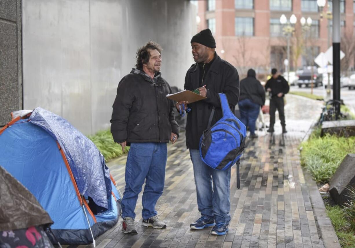 Joe Liles, 53, left, talks to Share outreach case manager Willie Hurst for the annual Point in Time count, a census of the homeless population. Liles said he’s been homeless since he lost his job with the railroad.