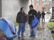 Joe Liles, 53, left, talks to Share outreach case manager Willie Hurst for the annual Point in Time count, a census of the homeless population. Liles said he’s been homeless since he lost his job with the railroad.