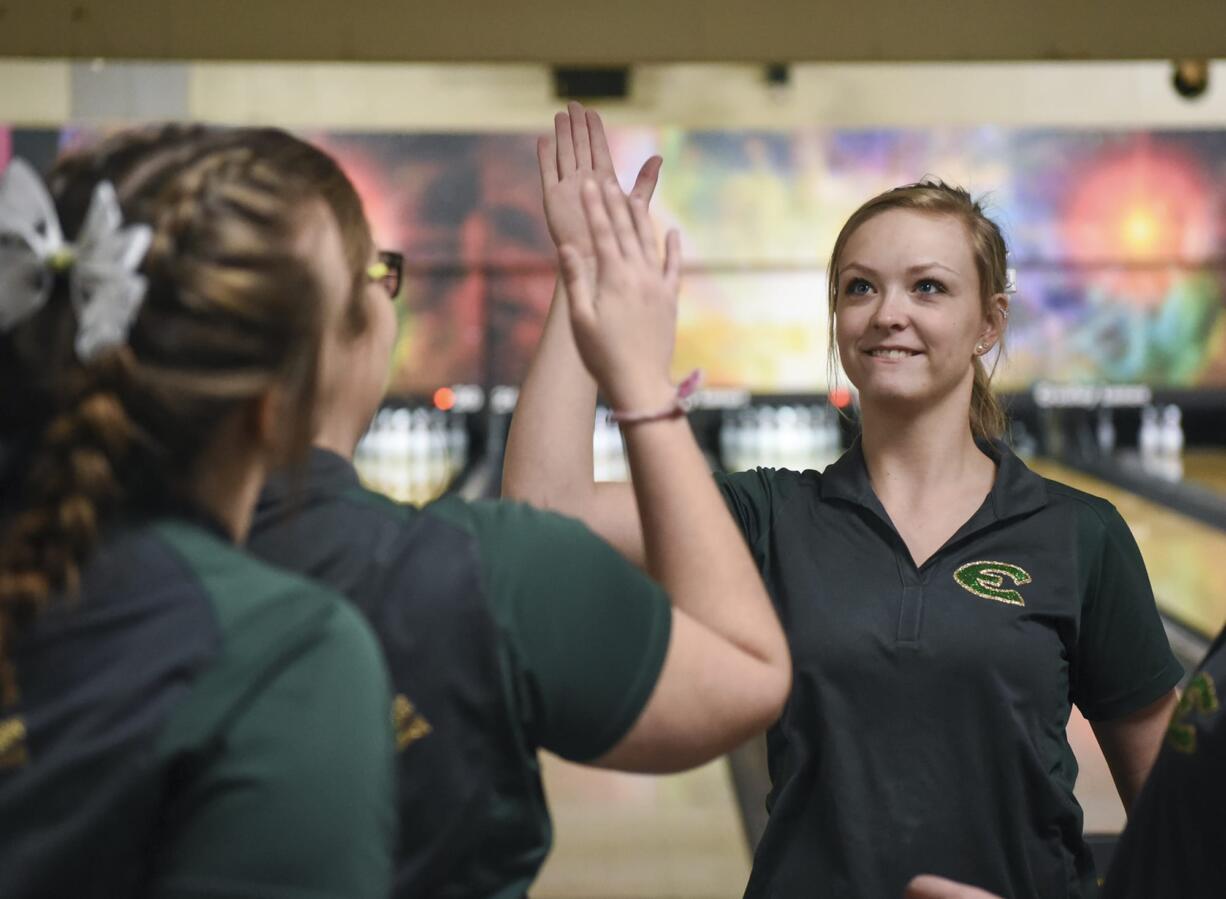 Evergreen’s Lexi Henderson, right,  high fives Jessica Dufrain during the 4A and 3A district girls bowling tournaments at Allen's Crosley Lanes in Vancouver, Friday January 26, 2018.