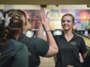 Evergreen’s Lexi Henderson, right,  high fives Jessica Dufrain during the 4A and 3A district girls bowling tournaments at Allen's Crosley Lanes in Vancouver, Friday January 26, 2018.