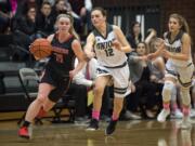 Camas' Haley Hanson (11) dribbles past Union's Abbey Kaip (12) during Friday night's game at Union High School on Jan. 26, 2018. The Papermakers won 53-33, clinching the 4A Greater St. Helens League title.