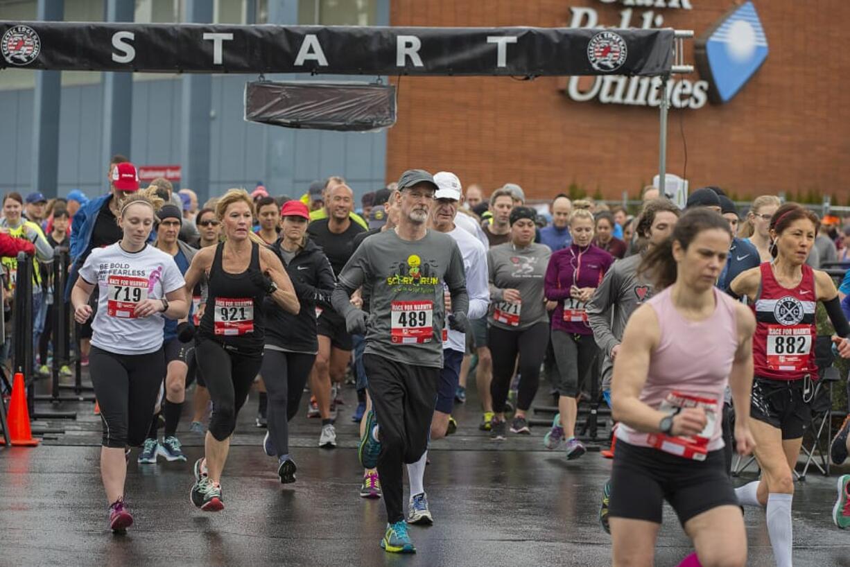 Runners in the Race for Warmth’s 10K race take off from the starting line Sunday morning. More than 1,300 people participated this year. The race is part of the fundraising for Clark Public Utilities’ home heating assistance program, which helped more than 800 households last year.