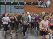 Runners in the Race for Warmth’s 10K race take off from the starting line Sunday morning. More than 1,300 people participated this year. The race is part of the fundraising for Clark Public Utilities’ home heating assistance program, which helped more than 800 households last year.