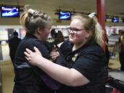 Haile Martin, a sophomore at Hudson's Bay HIgh School, left, does a special handshake with her sister, Jasmine 'Jazzie' Martin, a senior, after both girls make back-to-back strikes at the district tournament. Jazzie, who is deaf, has bowled all four years at Hudson's Bay.