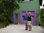 Jennifer and Mark Wyld of Vancouver stand outside their Hough neighborhood home and accessory dwelling unit in June.