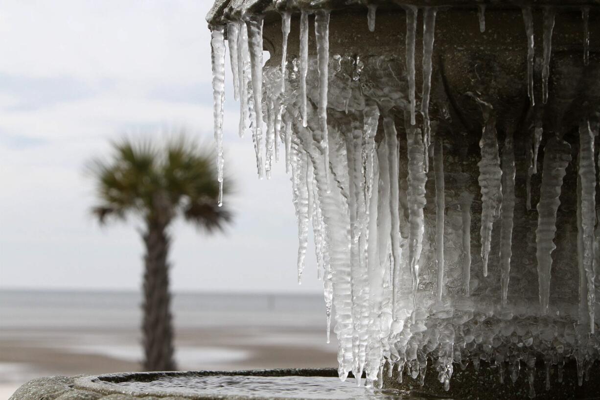 Icicles hang from the fountain at Beau View condominiums in Biloxi, Miss., on Monday, Jan. 1, 2018.