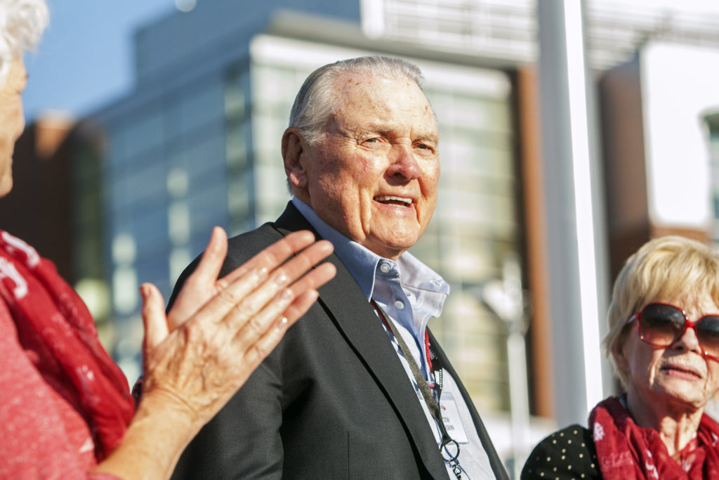 Washington State alumnus Keith Jackson smiles after raising the Cougar flag before the start of an  football game in 2014 at Martin Stadium in Pullman. Jackson, the down-home voice of college football during more than five decades as a broadcaster, died Friday, Jan. 12, 2018. He was 89.